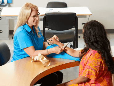 Therapist with patient working on arm