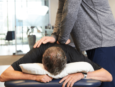 Therapist with patient working on back