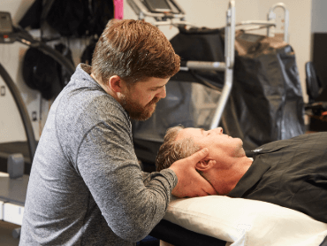 Therapist with patient working on head