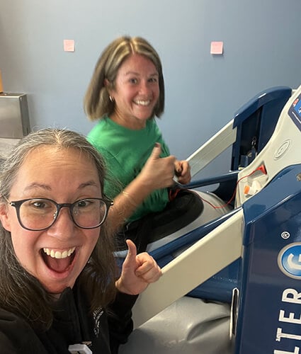 Teresa running on AlterG beside physical therapist Rebecca