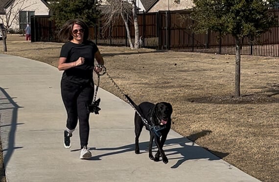 Teresa running outside with her dog