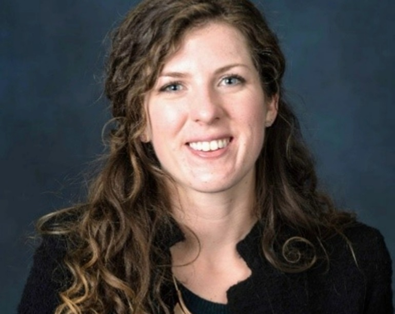 Kelley Wood smiling wide for her headshot photo.