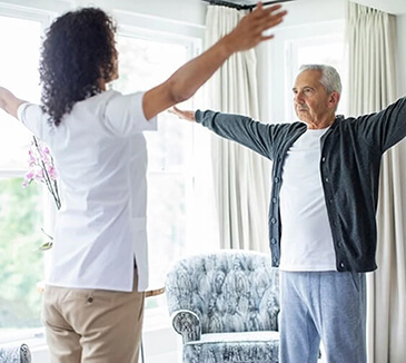 Man and woman standing, facing each other with raised arms.