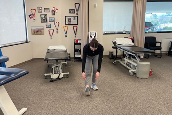 Therapist demonstrating walking scoops stretches.
