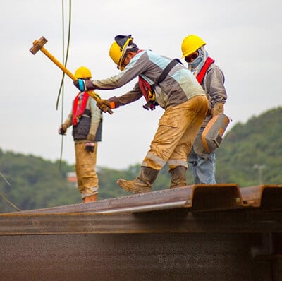 worker swinging sledge hammer